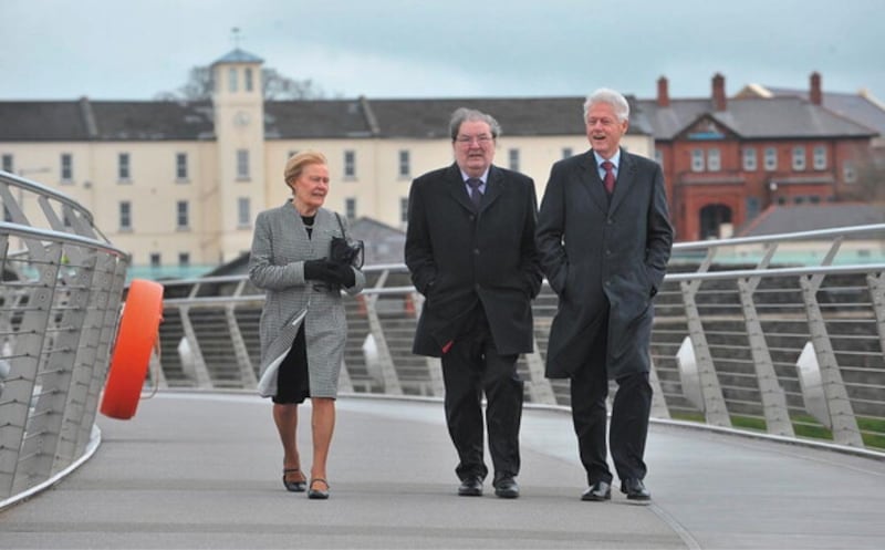 Former US President Bill Clinton walks with John and Pat Hume across the Peace Bridge in Derry as part of the Mr Clinton's 2014 visit to the city hosted by the University of Ulster