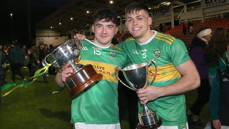 Eunan Mulholland (right) and Conleth McGuckian celebrate with the John McLaughlin Cup after Sunday's Derry SFC final win over Magherafelt. Picture by Margaret McLaughlin