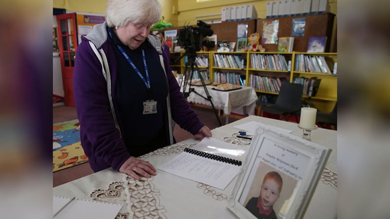 &nbsp;The principal of Harryville Primary School Lesley Meikle reads messages written in the book of condolence for five-year-old Kayden Fleck who died in Ballymena at the weekend