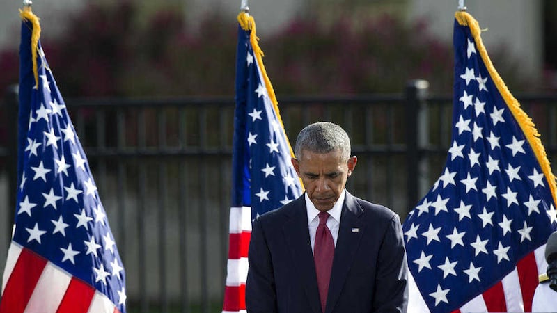 President Barak Obama bows his head for a moment of silence before delivering remarks at the September 11 memorial observance ceremony at the Pentagon. Picture by Cliff Owen, Associated Press