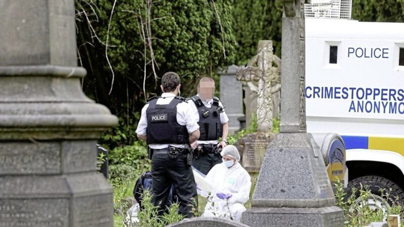 Police and forensic officers examine a suspect device in the City Cemetery in west Belfast. Picture by Mal McCann 