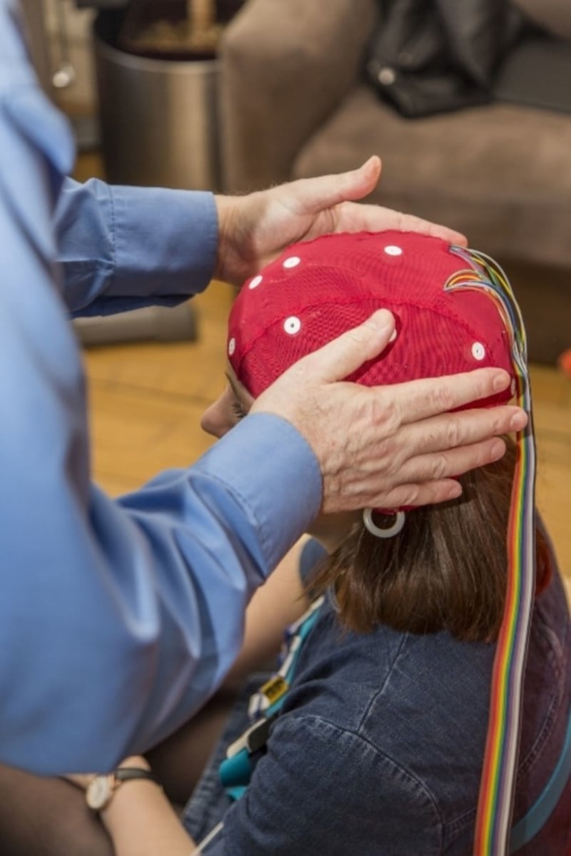 A participant having an EEG cap fitted