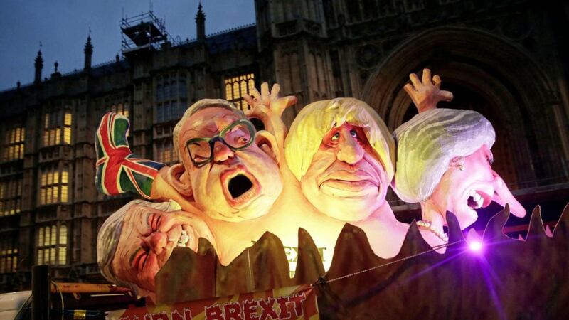 Effigies of British politicians from right, Prime Minister Theresa May, Boris Johnson and Michael Give are driven on a truck by anti-Brexit, remain in the European Union supporters outside the House of Parliament in London last week