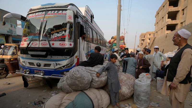 Afghan families wait to board in buses to depart for their homeland, in Karachi, Pakistan (AP Photo/Fareed Khan)