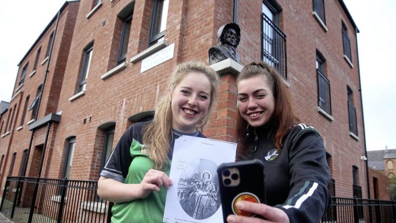 Ellene Rossi and Caitriona Liggett representing the Mary Ann McCracken Camogie club pose as a bust of the social campaigner is unveiled at the corner of Stanhope Street and Clifton Street in north Belfast. Picture by Mal McCann. 