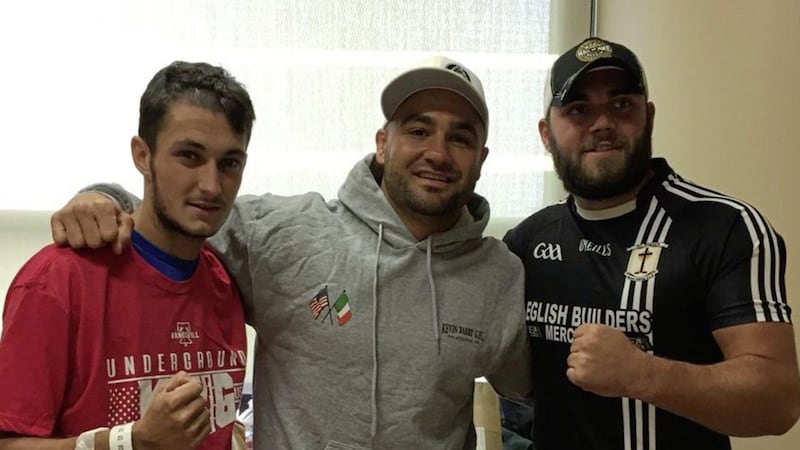 Aaron Elliot (left) pictured standing beside UFC star, Eddie Alvarez (middle) and another man. 