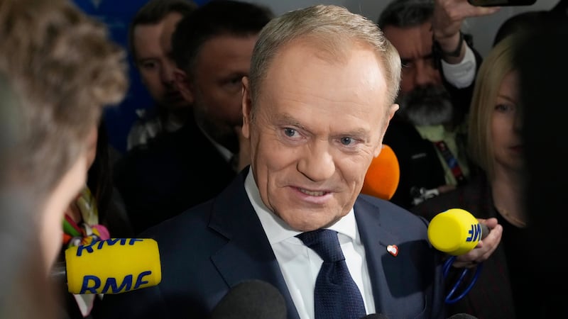 Polish opposition leader Donald Tusk speaks with reporters after the signing ceremony of a coalition agreement (AP Photo/Czarek Sokolowski)