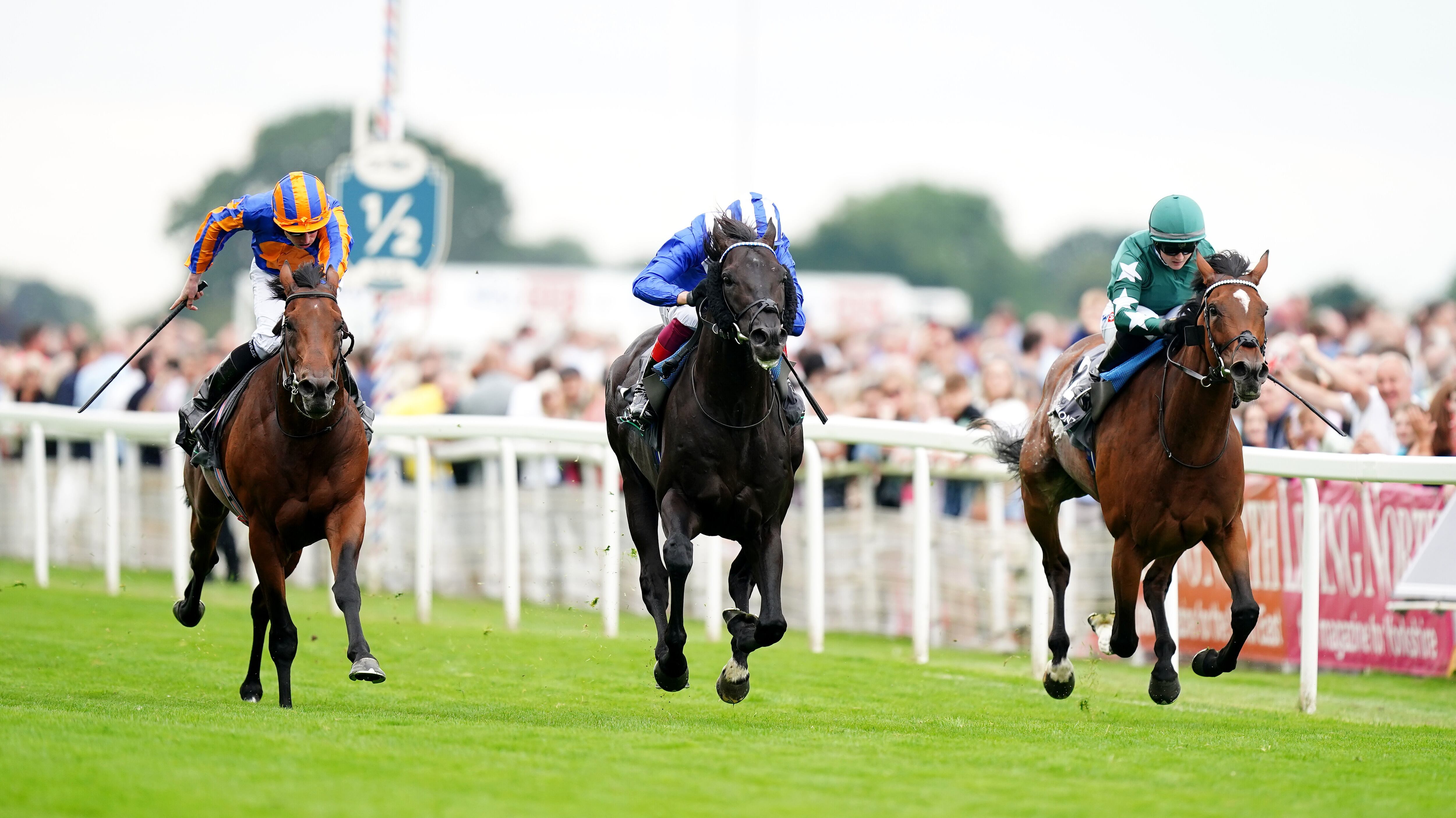 Mostahdaf, ridden by Frankie Dettori (centre), wins the Juddmonte International Stakes with Nashwa, under Hollie Doyle (right) second and Paddington, ridden by Ryan Moore, third on day one of the Sky Bet Ebor Festival at York Racecourse. Picture by PA