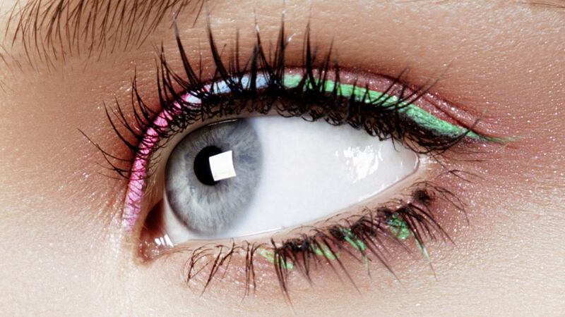 An eye make-up look with colourful eyeliner in pink, blue and green 