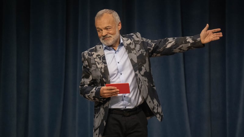 Graham Norton brandishes a red card in a scene from LOL: Last One Laughing Ireland