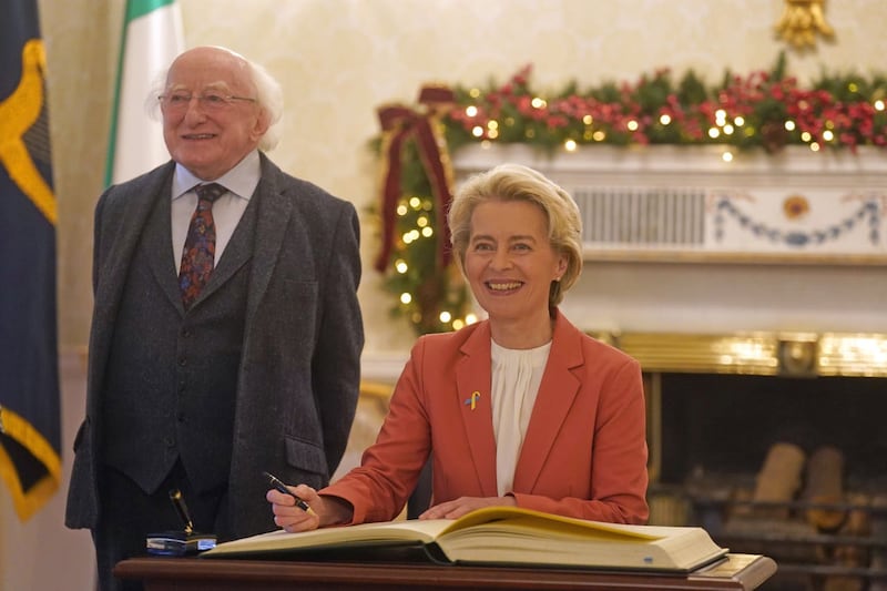 European Commission President Ursula von der Leyen signs the distinguished guests book as she meets President Michael D Higgins at Houses of Oireachtas in Dublin in 2022
