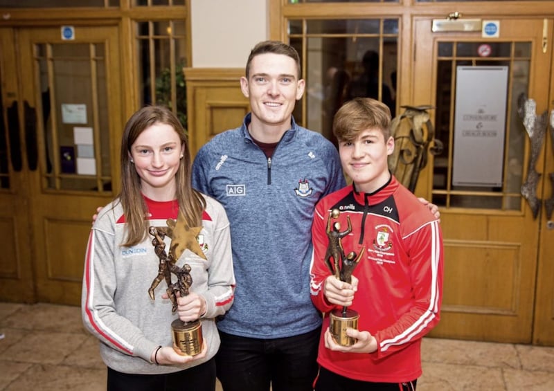 Dublin star Brian Fenton with Rossa U14 girls' and boys' All-Ireland winning Feile captains Annie Kilpatrick and Conall Heron. Picture by Catherine Comer