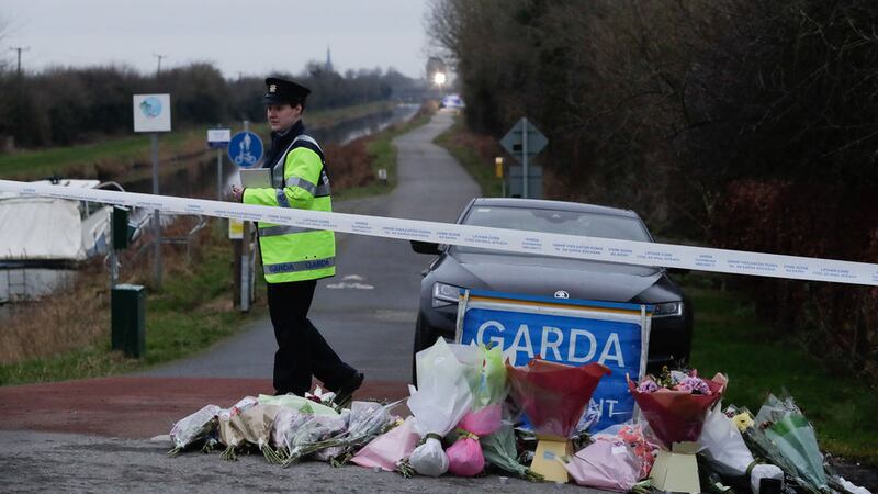 A garda on duty besides the floral tributes left near to the Grand Canal in Tullamore, County Offaly, where Aisling Murphy was murdered on Wednesday evening. Picture by Damien Eagers/PA Wire&nbsp;