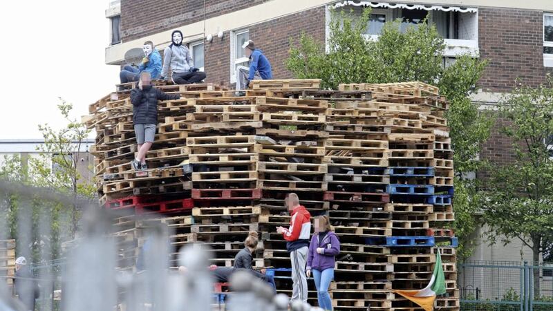 Youths sit on top of pallets collected in the New Lodge area of north Belfast 