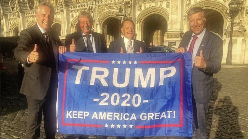 East Antrim MP Sammy Wilson had posted a picture of himself and party colleagues Ian Paisley and Paul Girvan smiling with their thumbs up behind a `Trump&#39; flag in September 