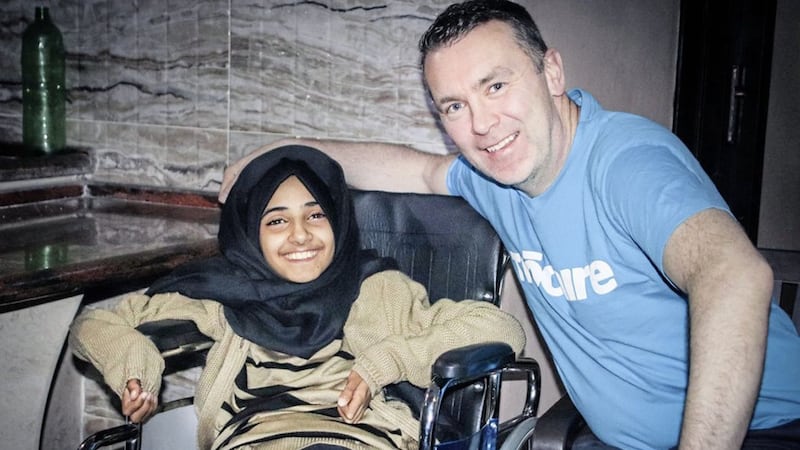 Maha Al-Sheikh Khalil (13), who was paralysed in 2014, when Israeli airstrikes hit her house when she was only eight years old, pictured with Ois&iacute;n McConville. 