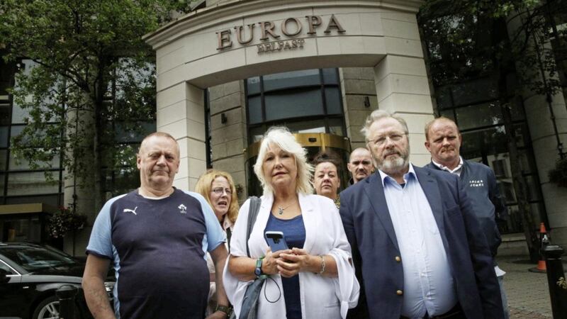 Margaret McGuckian and members of Savia on the way out of the Europa Hotel in Belfast. Picture by Hugh Russell 