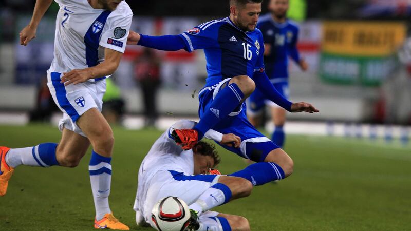 Oliver Norwood rides a tackle from Finland's Paulus Arajuuri during last Sunday's Euro 2016 qualifier at the Olympic Stadium in Helsinki<br />Picture: PA&nbsp;