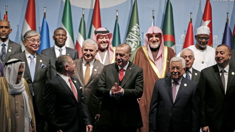 Turkey&#39;s president Recep Tayyip Erdogan, centre, flanked by Jordan&#39;s King Abdullah II, left and Palestinian president Mahmoud Abbas, right, applauses following a photo-op prior to the opening session of the Organisation of Islamic Cooperation Extraordinary Summit in Istanbul Lefteris Pitarakis/AP 