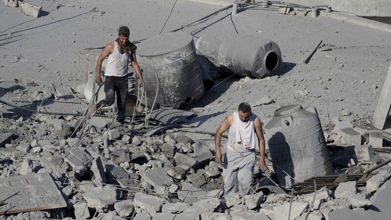 Palestinians look for survivors in the Nusseirat refugee camp in the Gaza Strip after an Israeli strike on Saturday