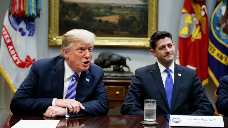 Former speaker Paul Ryan listens to Donald Trump (AP)