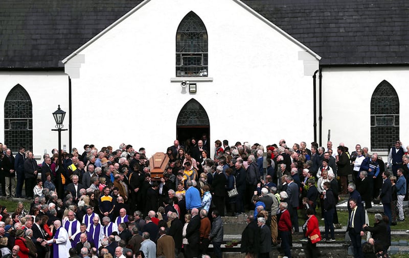 The coffin of Big Tom McBride is taken from Saint Patrick's Church in Oram, County Monaghan, during the funeral of the country music star&nbsp;