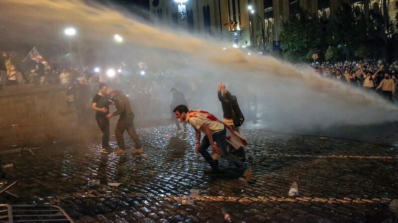 Riot police use a water cannon against protesters in Tbilisi (Zurab Tsertsvadze/AP)