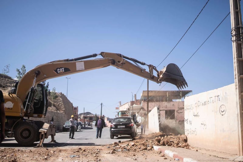 A tractor helps remove rubble during a rescue operation for people affected by the earthquake in Moulay Brahim village, near Marrakech, Morocco