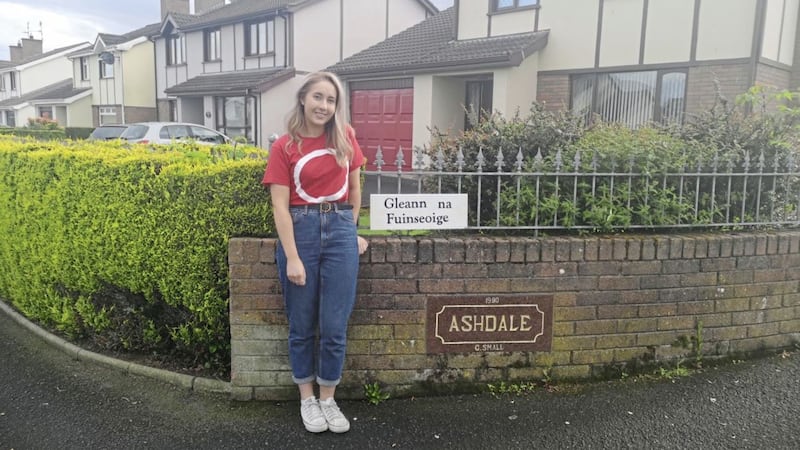 The pensioner's granddaughter, Medb N&iacute; Dh&uacute;l&aacute;in, with the Irish street sign