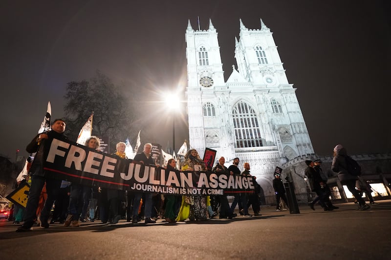 Campaigners pressing for the release of WikiLeaks founder Julian Assange take part in a demonstration during a Night Carnival outside Westminster Abbey