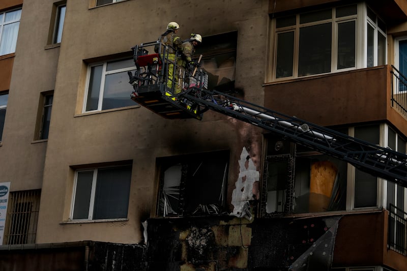 Firefighters work in the aftermath of a fire in a nightclub in Istanbul, Turkey (Khalil Hamra/AP)