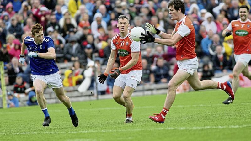 Armagh&#39;s Jarlath Og Burns with Mark Shields in action with Cavan&#39;s Jason McLoughlin in the Ulster Football semi-final game at Clones on Sunday June 2 2019. Picture by Seamus Loughran. 