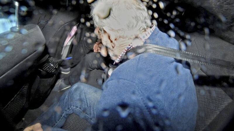 John Downey arriving in the back of a police car at Dublin Courts on Monday 