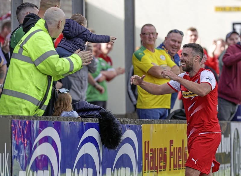 Joe Gormley celebrates his goal with son Lorcan at Stangmore Park last week 