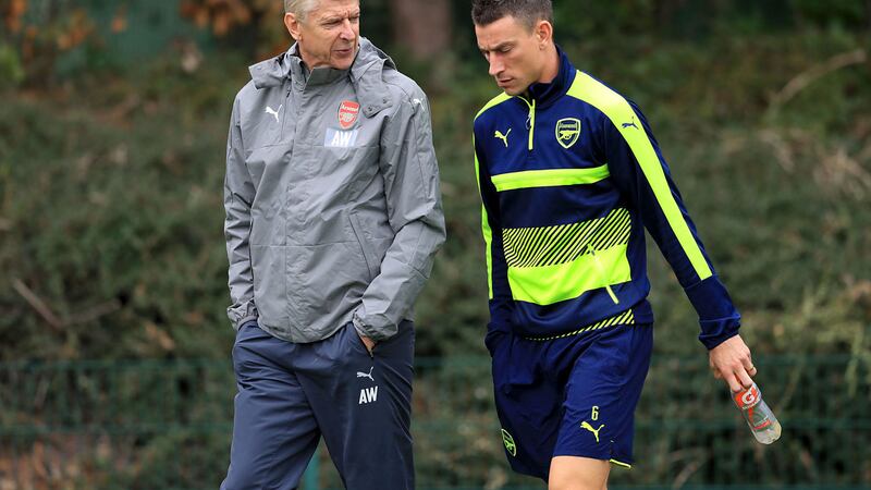 Arsenal manager Arsene Wenger speaks with Laurent Koscielny during a training session at London Colney on Tuesday<br />Picture by PA