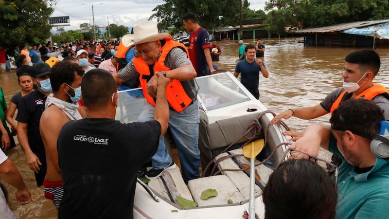 &nbsp;A resident is helped off a boat after he was rescued from a flooded area in the neighborhood of Planeta, Honduras, on November&nbsp;5 2020.&nbsp;The storm had initially hit Nicaragua as a Category 4 hurricane. Picture by&nbsp;Delmer Martinez, AP Photo