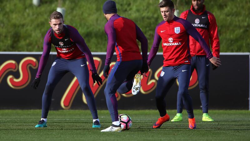 England's Jordan Henderson with Arron Cresswell try to get the ball off Theo Walcott as Daniel Strurridge looks on during Thursday's training session at St George's Park, Burton<br />Picture by PA&nbsp;