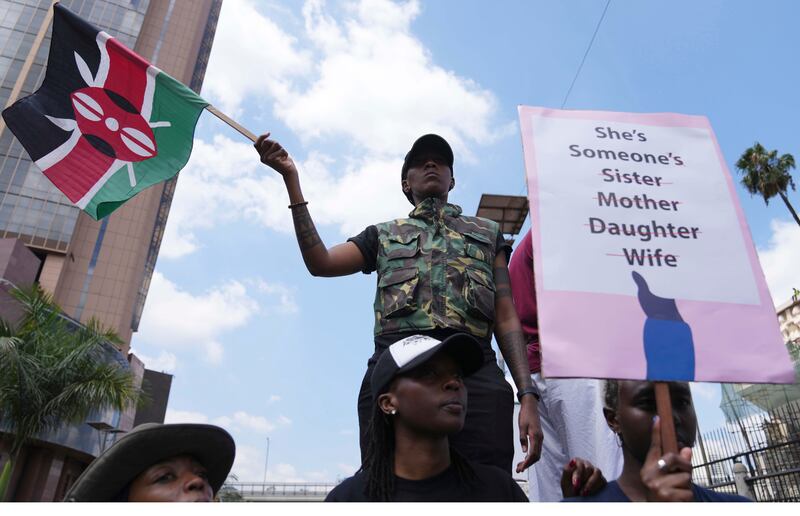 A protester holds a Kenyan flag during a procession to protest against the rising cases of femicide in Nairobi (AP Photo/Brian Inganga)