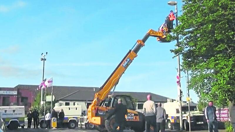 &lsquo;PROVOCATIVE ACT&rsquo;: A cherry picker is used to put up loyalist flags at Twaddell this week 