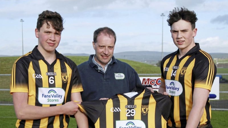 Fane Valley, Ballycastle store manager Andrew Christie presents new jerseys to Ballycastle U16 captain Oscar Egan (right) and vice-captain Cormac Donnelly (left) 