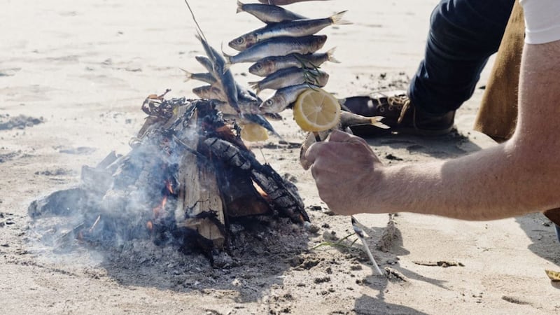 Hidden Hut chef Simon Stallard cooks sardines on the beach 