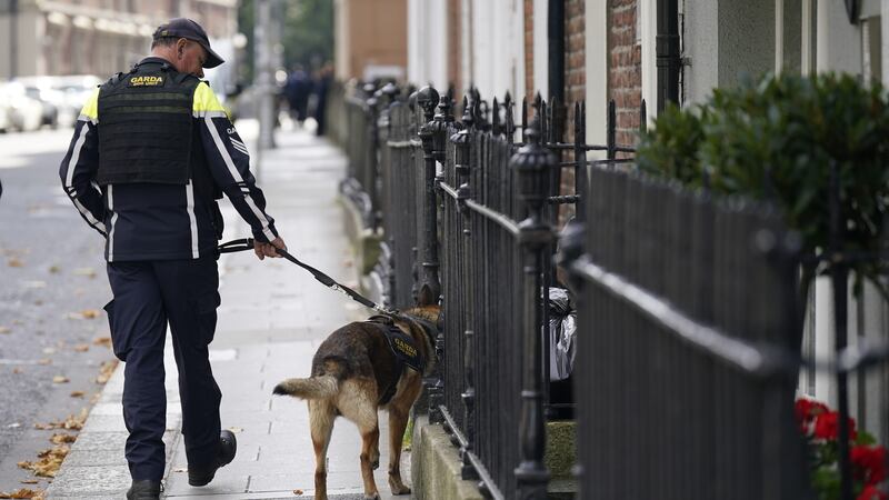 An officer conducts a security check near Leinster House ahead of the Budget announcement (Niall Carson/PA)