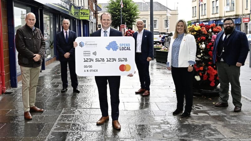 Around 100,000 people in Northern Ireland fail High Street Voucher Scheme verification process. Pictured is Economy Minister Gordon Lyons with the &pound;100 card. Picture Department for the Economy/PA Wire 