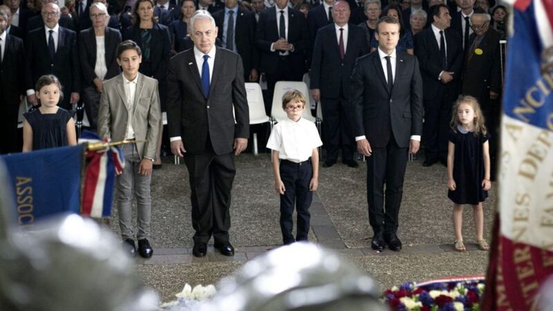 CEREMONY: Israeli prime minister Benjamin Netanyahu, third left, and French president Emmanuel Macron, second right, pay their respects yesterday after laying a wreath at the Vel d&rsquo;Hiv roundup memorial, during a ceremony commemorating the 75nd anniversary of the Vel d&rsquo;Hiv roundup. French Jewish leaders are giving speeches at an emotional ceremony at the Vel d&rsquo;Hiv stadium outside Paris, where French police rounded up some 13,000 people on July 16-17, 1942 before they were sent on to camps. Fewer than 100 survived	 					     Picture: Kamil Zihnioglu/Pool/AP 