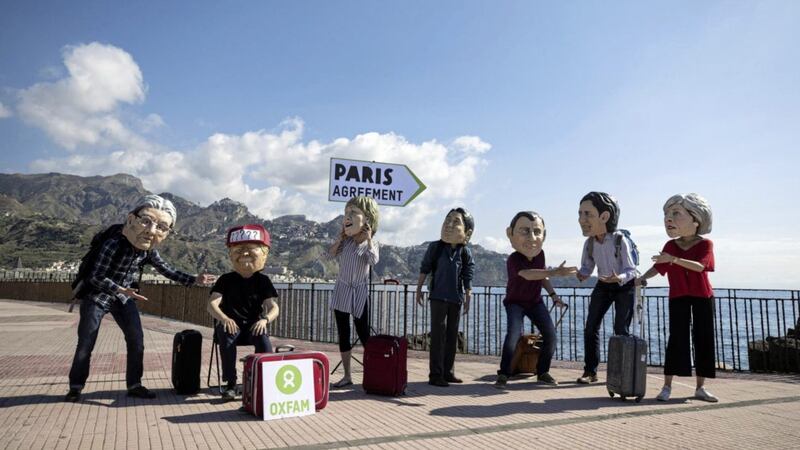 Oxfam activists wearing masks of the leaders of the G7 summit; from left, Italian Premier Paolo Gentiloni, US president Donald Trump, German Chancellor Angela Merkel, Japanese Prime Minister Shinzo Abe, French President Emmanuel Macron, Canadian Prime Minister Justin Trudeau, and British Prime Minister Theresa May stage a demonstration in Giardini Naxos, near the venue of the G7 summit in the Sicilian town of Taormina, southern Italy. Picture by Angelo Carconi/ANSA via Associated Press 
