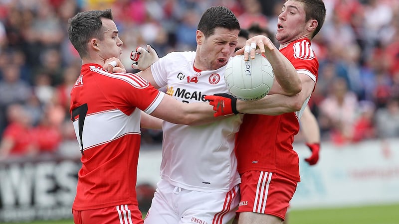 <address>Tyrone captain Sean Cavanagh got it tough in this instance but his team won comfortably overall against Derry.<br/>Pic Philip Walsh