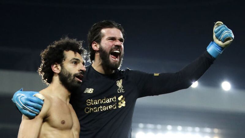 Liverpool 'keeper Alisson celebrates with Mo Salah after the Brazilian set the Egyptian up for the second goal at Anfield yesterday<br />Picture by PA&nbsp;
