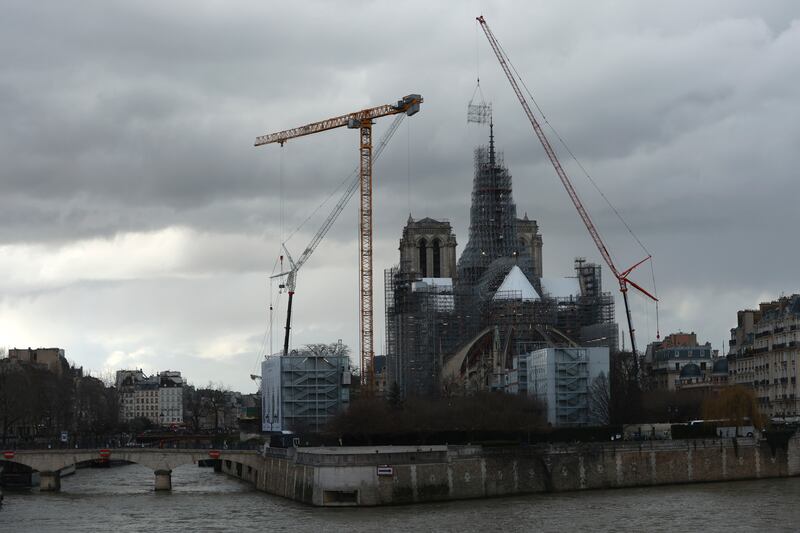 Much of the cathedral, which is on track to open in December this year, remains surrounded by scaffolding (Aurelien Morissard/AP)