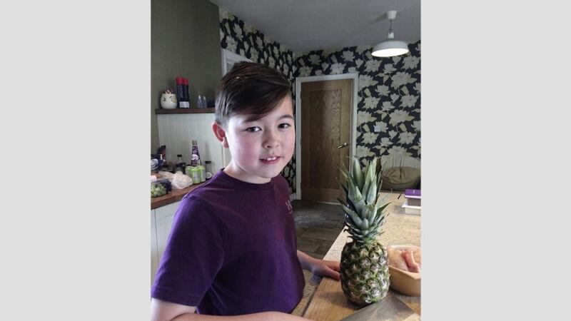 Adam Cooper (11) in his family kitchen in Ballyoney, Co Antrim 