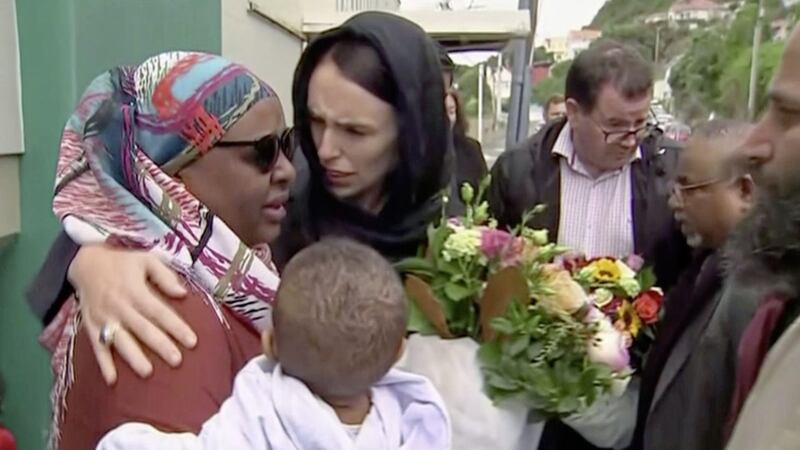 New Zealand prime minister Jacinda Ardern, pictured centre, hugs and consoles a woman as she visited Kilbirnie Mosque to pay tribute to the Christchurch attack victims. Picture by TVNZ via AP 